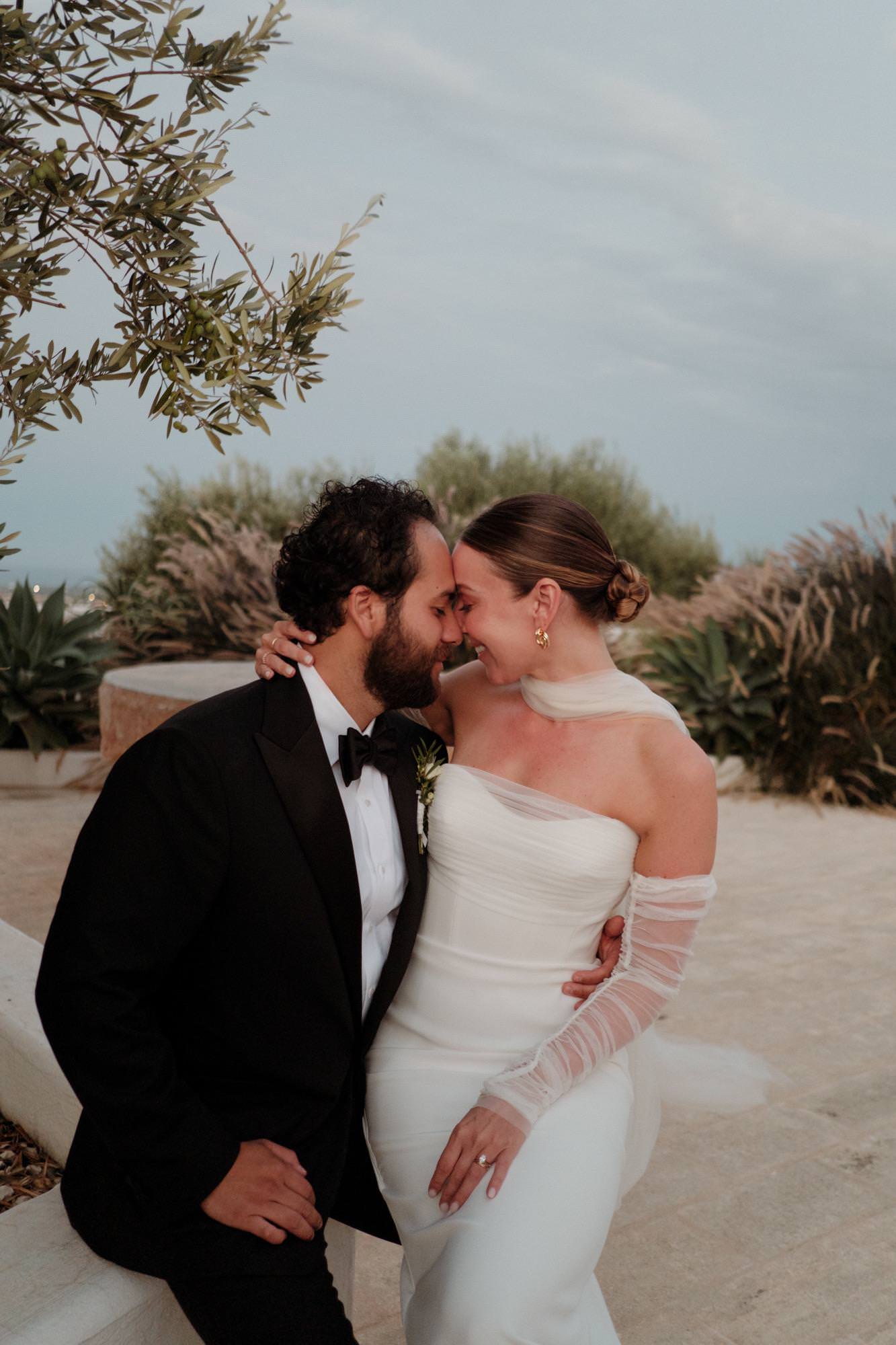 destination wedding with rusched sleeve gloves and tulle neck scarf on bride